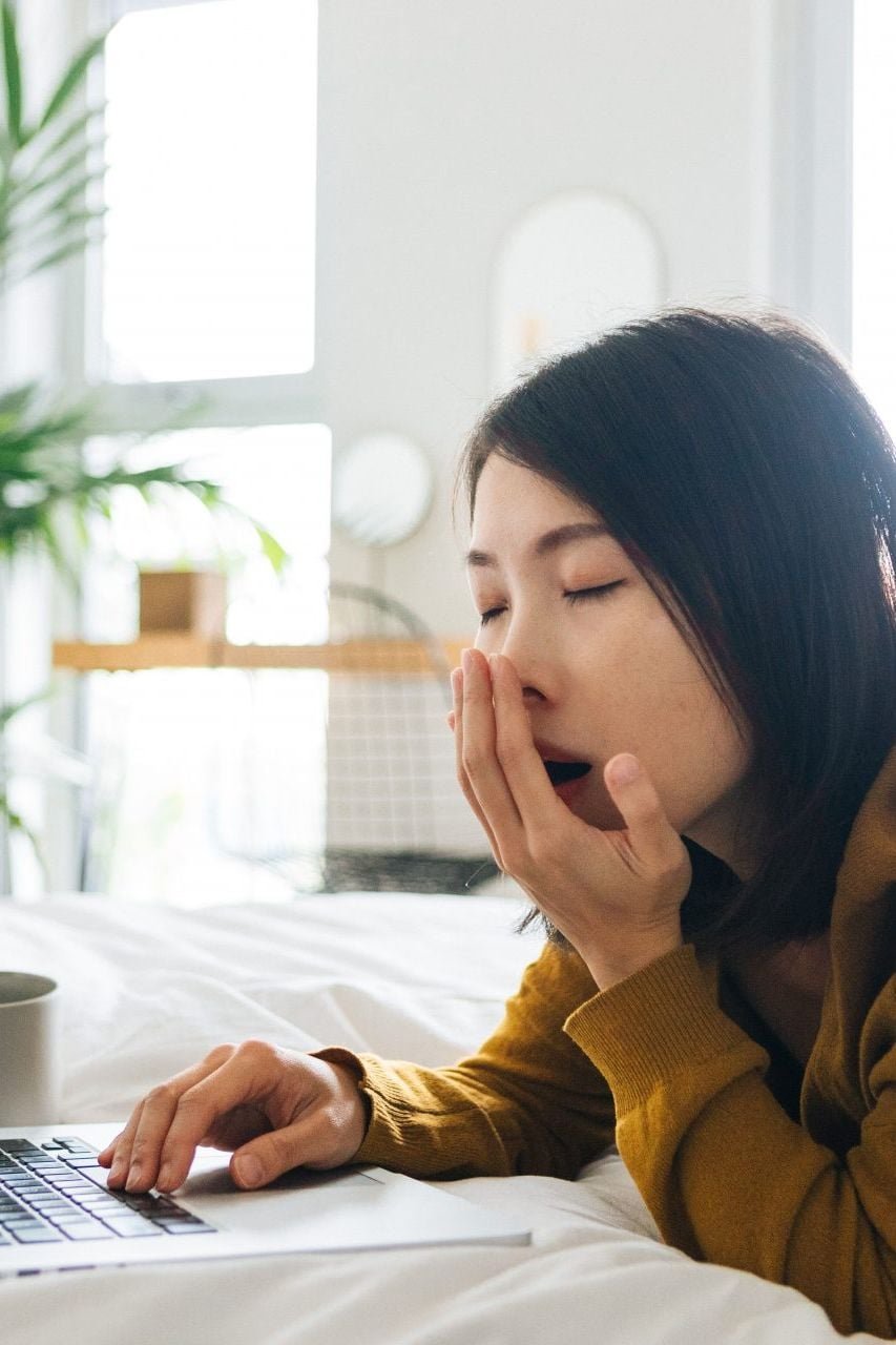 Tired woman yawning