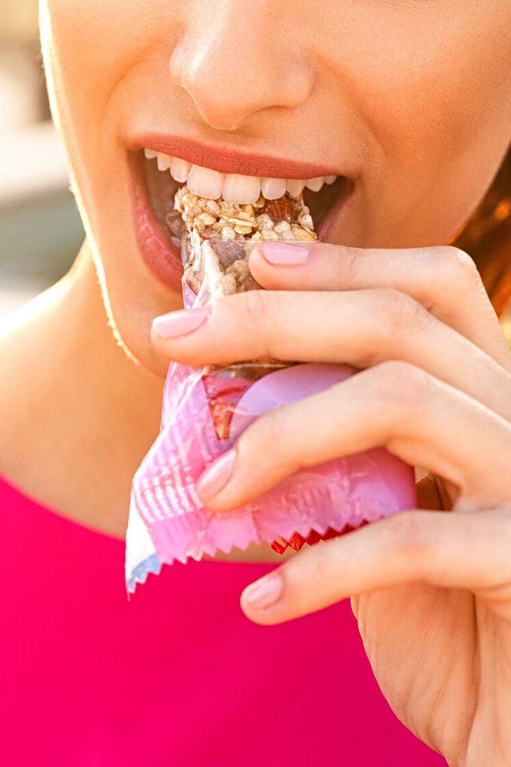 Woman eating a protein bar