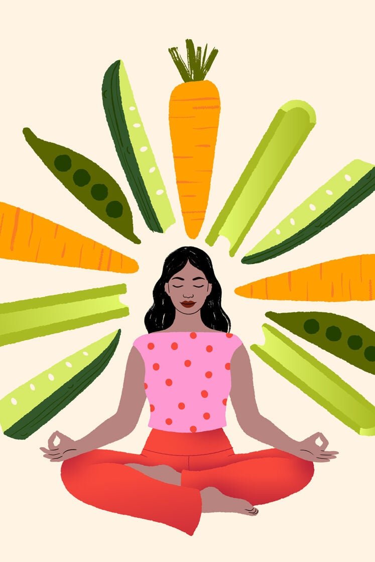 Image of a woman seated surrounded by vegetables