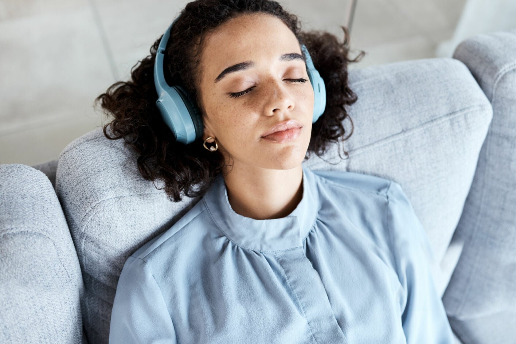 woman listening to podcast on headphones