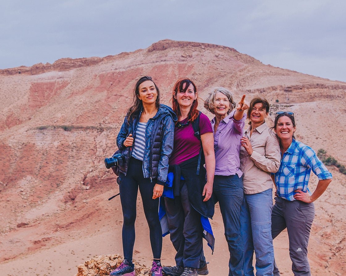 Image featuring five women standing in front of a mountain