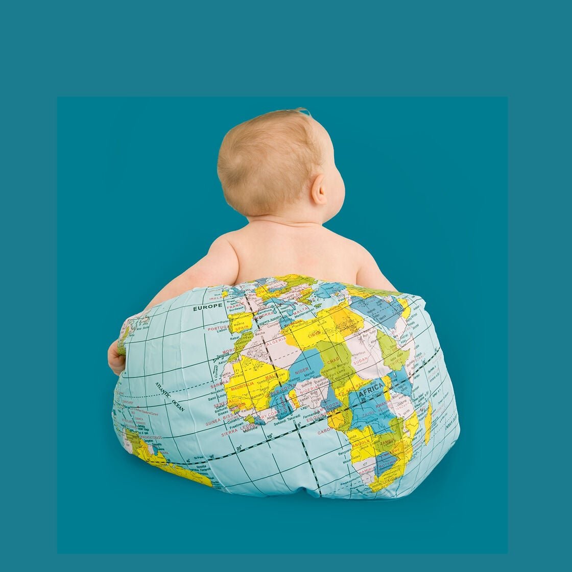 baby sitting on globe - childcare around the world