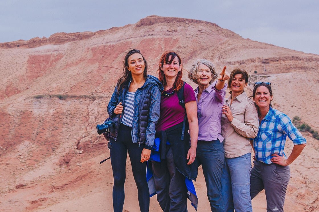 Image featuring five women standing in front of a mountain