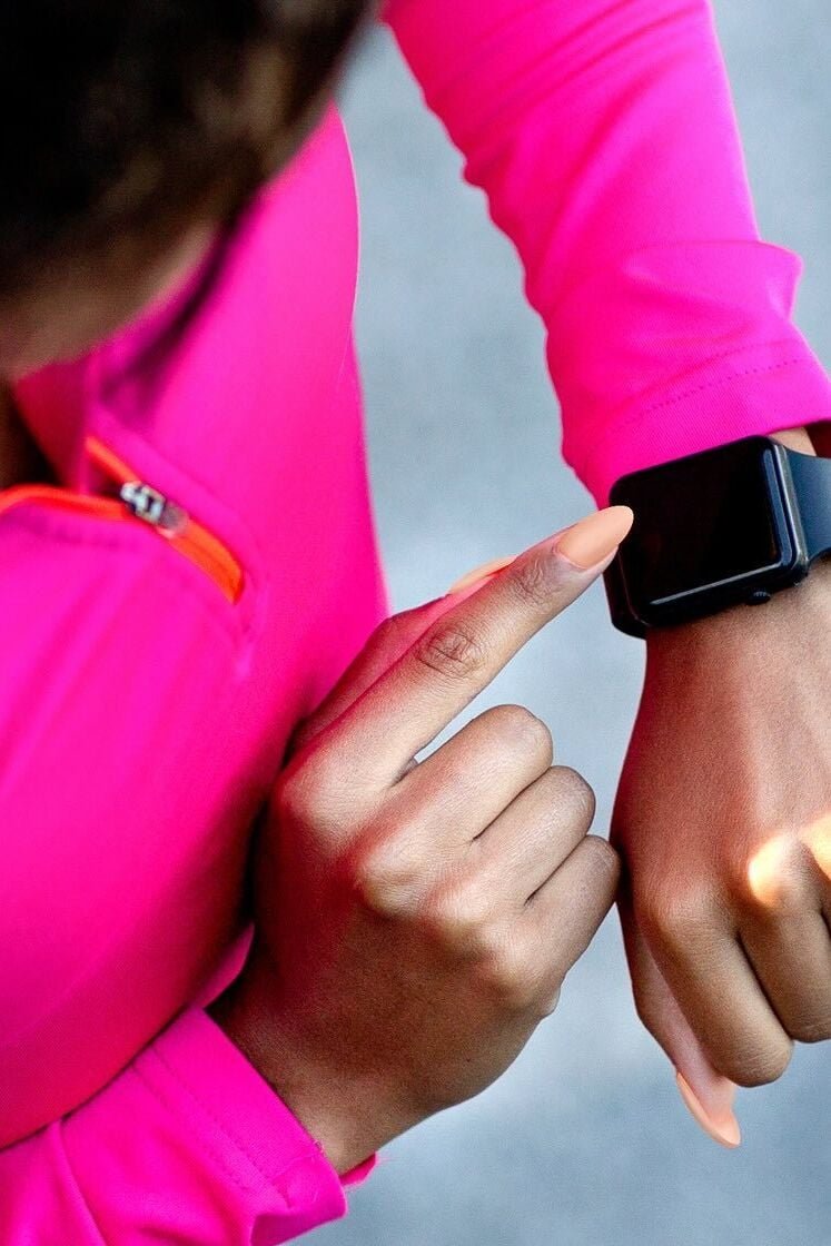 A woman looking at her health tracker
