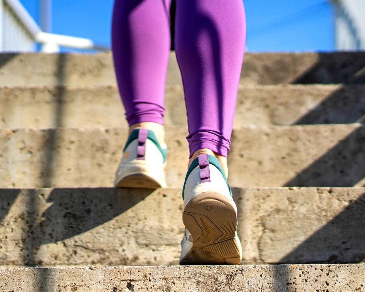 A woman's feet running up stairs