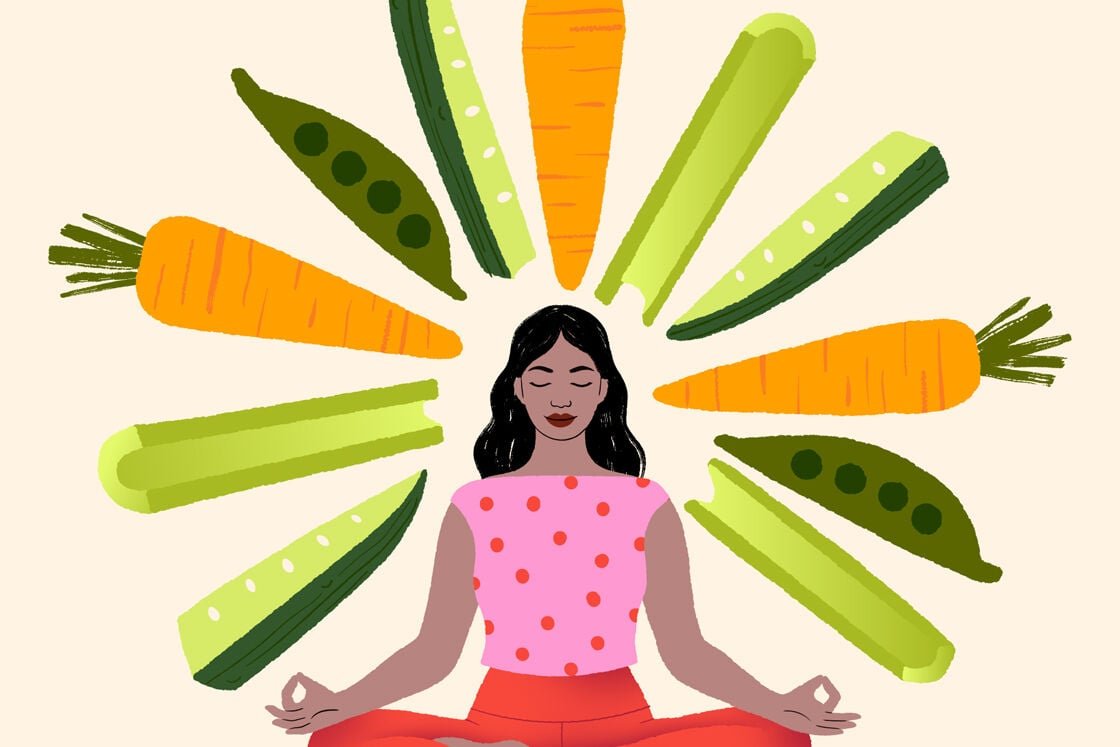 Image of a woman seated surrounded by vegetables
