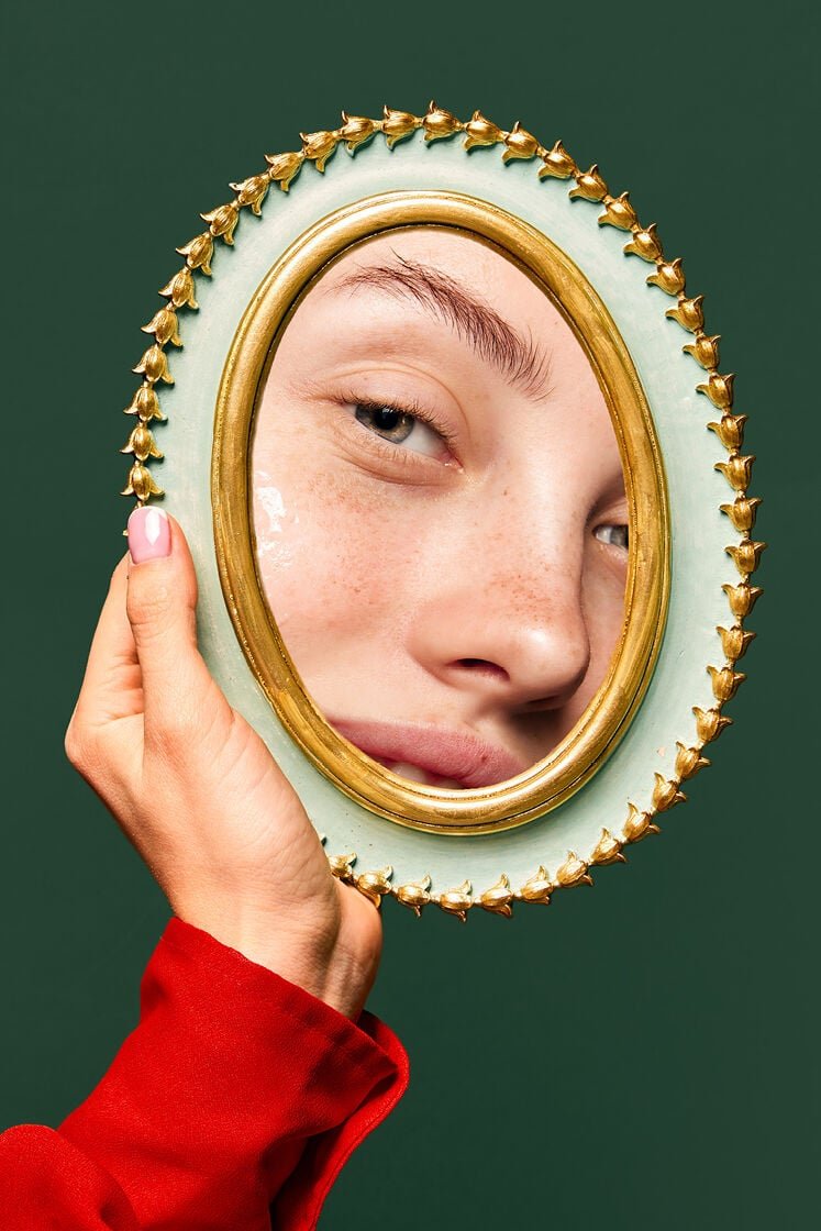 woman looking in mirror