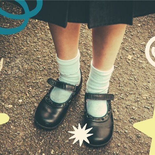 A little girl's school shoes and socks
