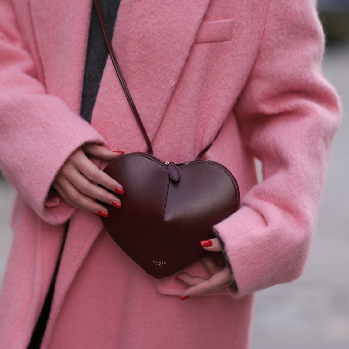 Street style wearing heart bag