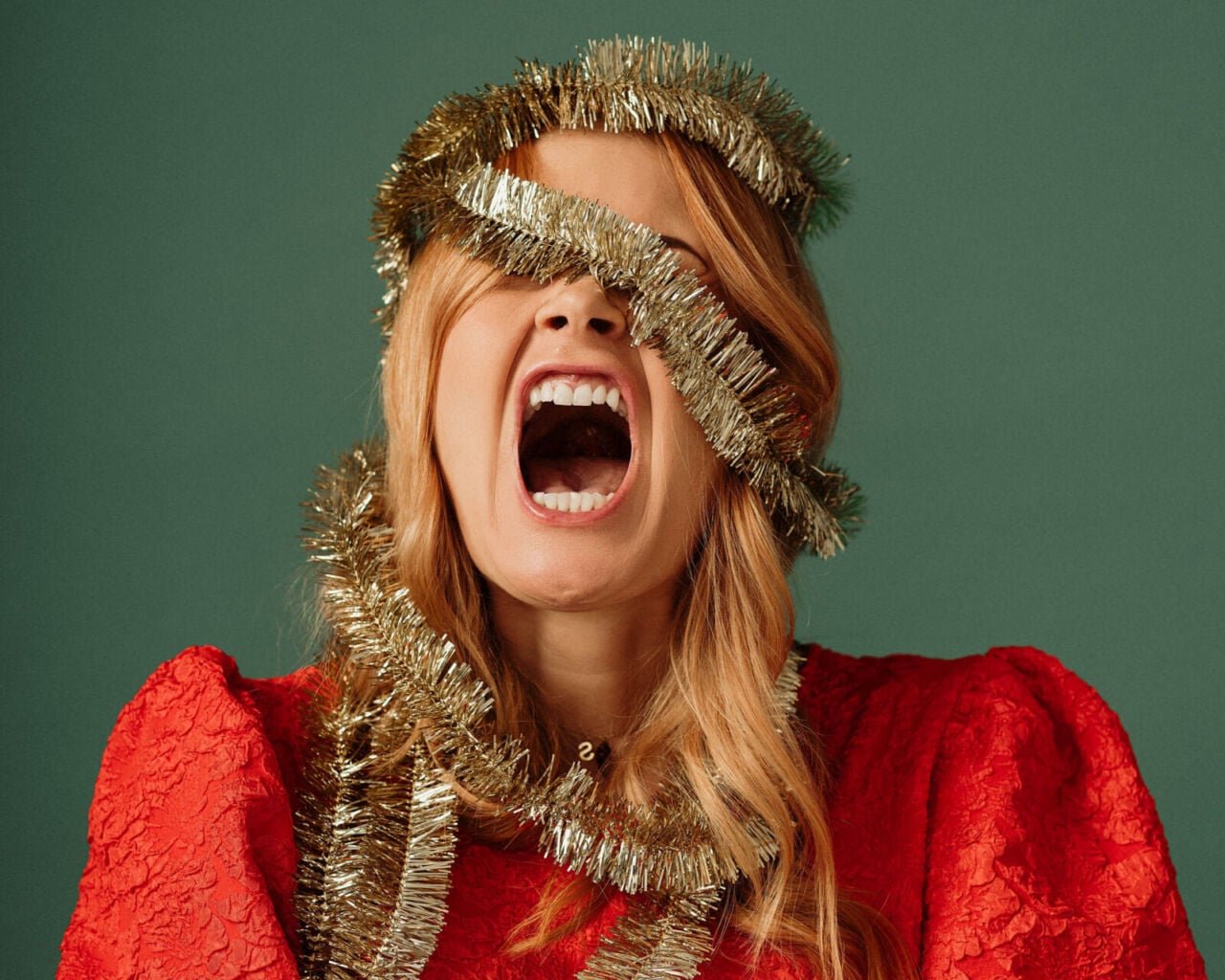 Woman screaming wrapped in tinsel Christmas load