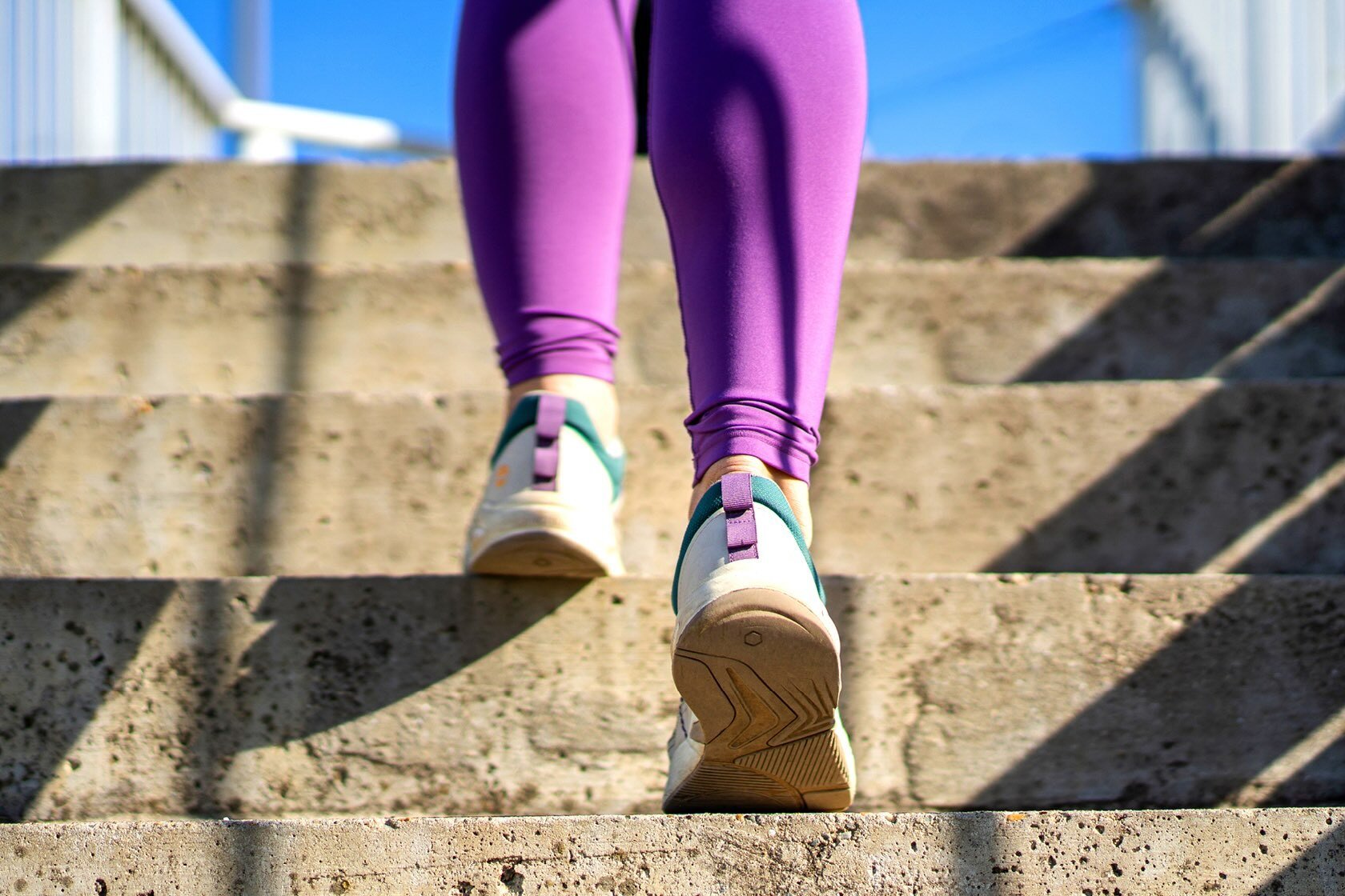 A woman's feet running up stairs