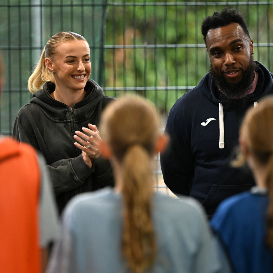 LONDON, ENGLAND - OCTOBER 13: Chloe Kelly chats to pupils with Saving Souls Hub founder Kerry Phillips on a surprise visit to members of Saving Souls Hub and pupils at The Charter School North Dulwich on October 13, 2025 in London, England.