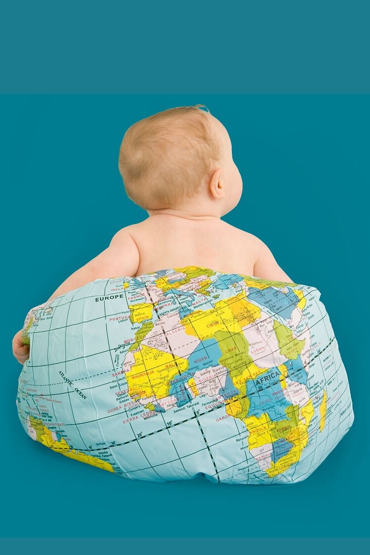 baby sitting on globe - childcare around the world