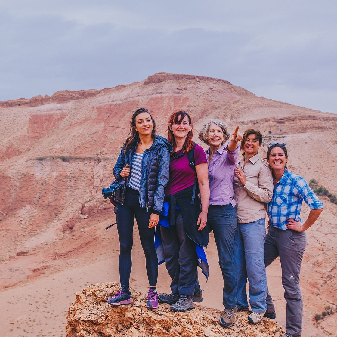 Image featuring five women standing in front of a mountain